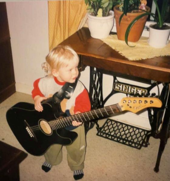 Bilde av Morgan som barn med stor gitar
